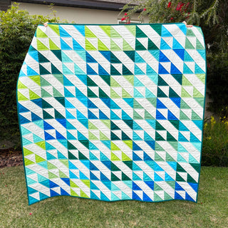 Kinetic Quilt Pattern (Download) by Homemade Emily Jane featuring a bold modern geometric quilt in blue green and white triangles creating a sense of motion