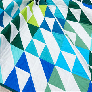Kinetic Quilt Pattern (Download) featuring bold geometric shapes in blue green turquoise and white by Homemade Emily Jane for modern quilting enthusiasts