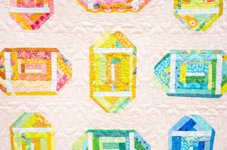 Log Cabin Lateral Quilt Pattern (Download) by Jessica Steele Design featuring colorful geometric log cabin quilt blocks on a soft background