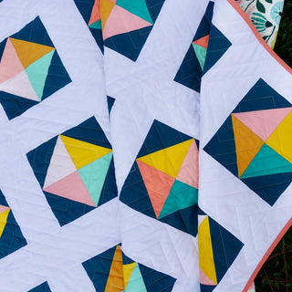 Solitaire Quilt Pattern (Download) by Homemade Emily Jane featuring colorful geometric quilt blocks on a crisp white background with bold modern movement