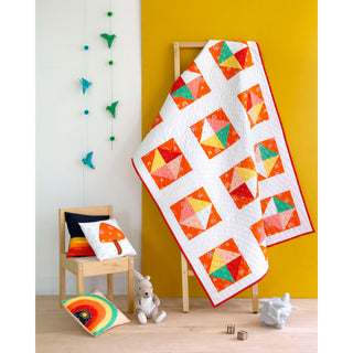 Solitaire Quilt Pattern (Download) by Homemade Emily Jane featuring a modern geometric quilt with vibrant orange teal and white blocks displayed on a wooden stand