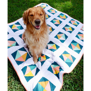 Solitaire Quilt Pattern (Download) by Homemade Emily Jane featuring a cheerful golden retriever on a modern geometric quilt with teal coral yellow and white blocks