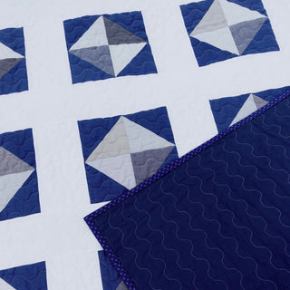 Solitaire Quilt Pattern (Download) by Homemade Emily Jane featuring a modern blue and white geometric quilt design with elegant movement and contrast