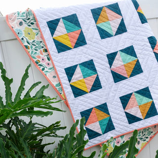 Solitaire Quilt Pattern (Download) by Homemade Emily Jane, a modern quilt with colorful geometric triangle blocks on a crisp white background